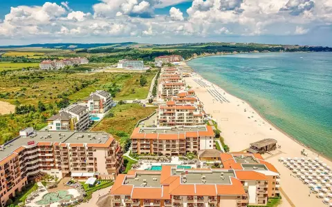 Widok z lotu ptaka na kurort nad Morzem Czarnym. Kompleksy hotelowe z basenami i plażą z leżakami. Czy w Bułgarii jest drogo?