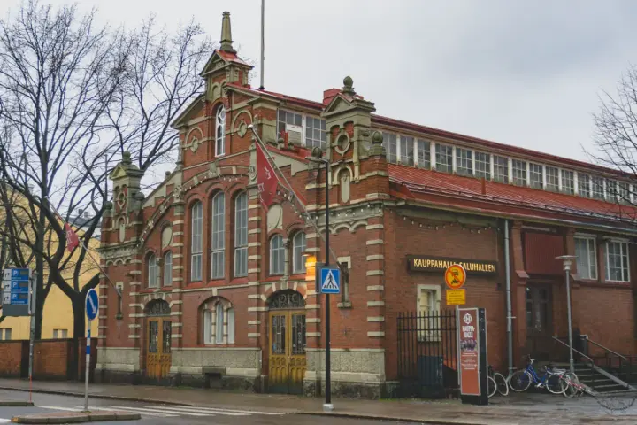 Targowisko Kauppahalli w Turku, najstarszym mieście w Finlandii, z charakterystyczną ceglaną fasadą i czerwonym dachem.
